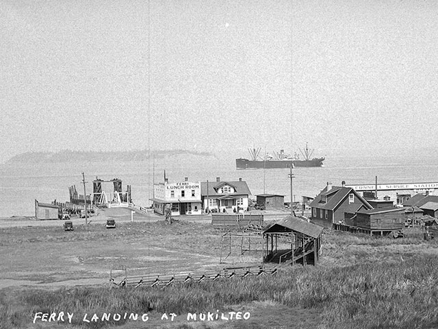A 1920 view of the newly constructed ferry landing at Mukilteo built to support boats running between Mukilteo and the town of Clinton on Whidbey Island to the west. 
Photo courtesy of Everett Public Library, photographer J.A. Juleen. 
