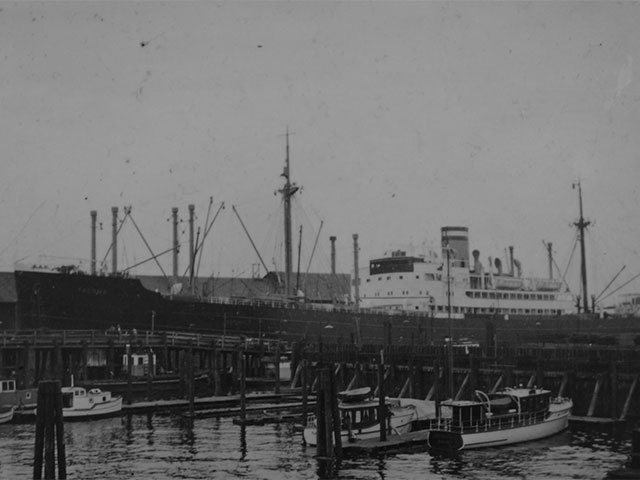 Ship docked at Pier 1 with the early commercial and pleasure boat marina in the forefront, circa 1920s. 
Photo courtesy of Port of Everett. 
